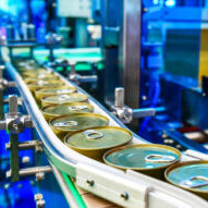 Canned,Food,Products,On,Conveyor,Belt,In,Distribution,Warehouse.parcels,Transportation